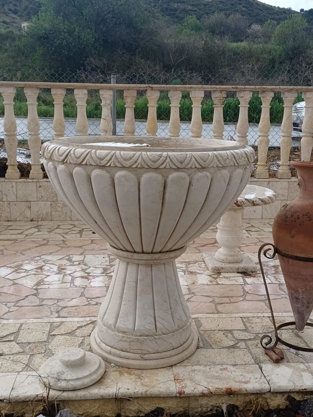 Stone balustrade with a matching carved planter