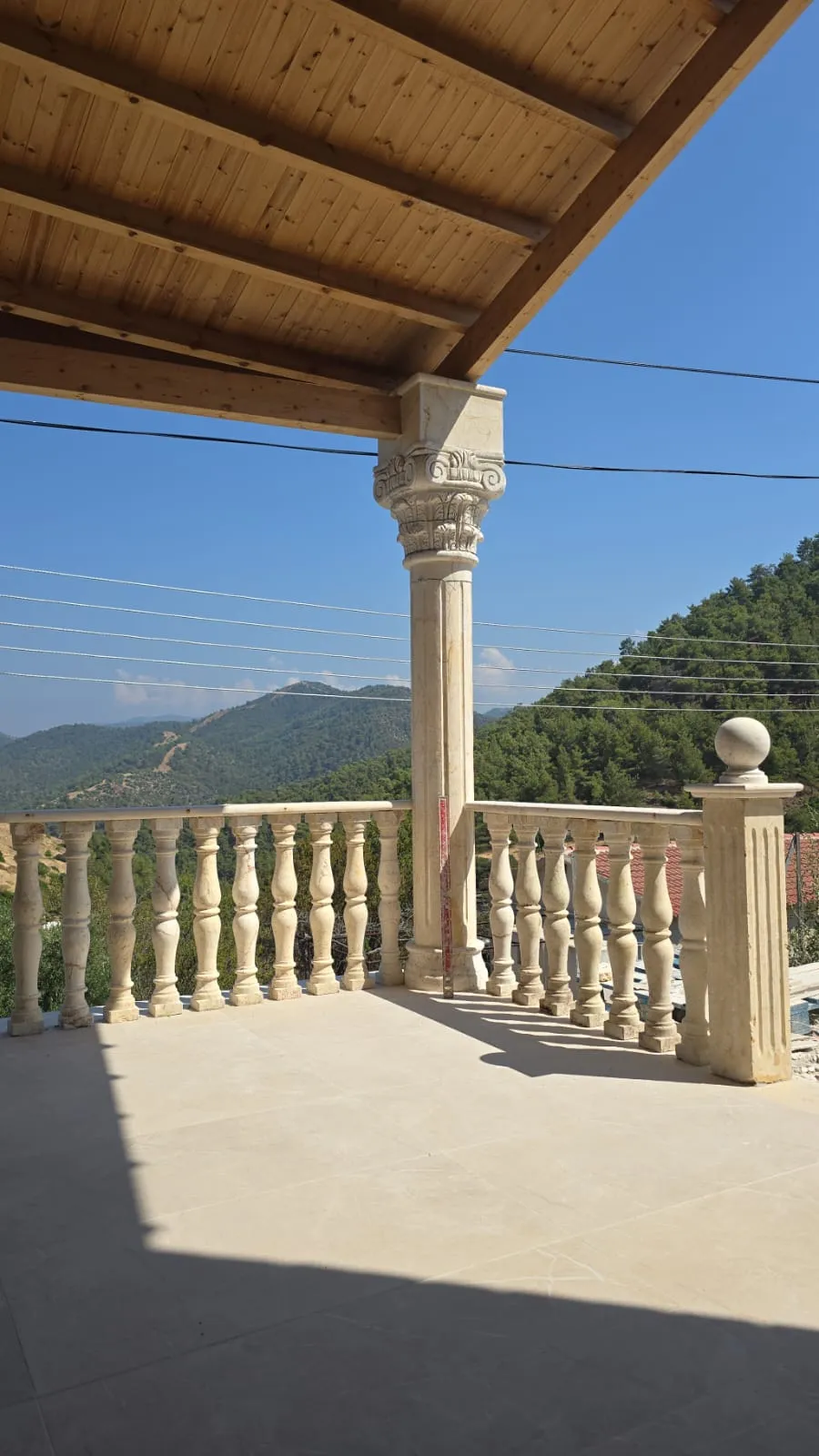Turned stone balusters on a covered terrace