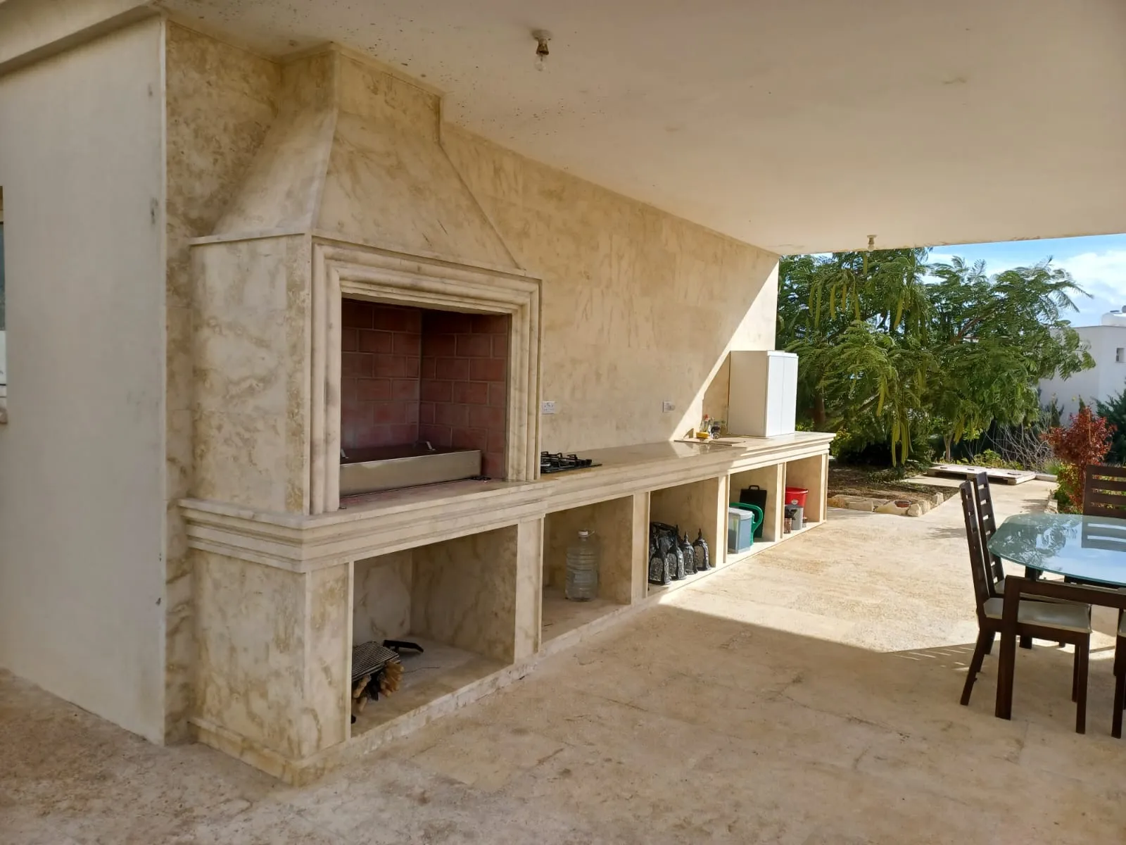 Outdoor kitchen with stone worktops and a built-in barbecue