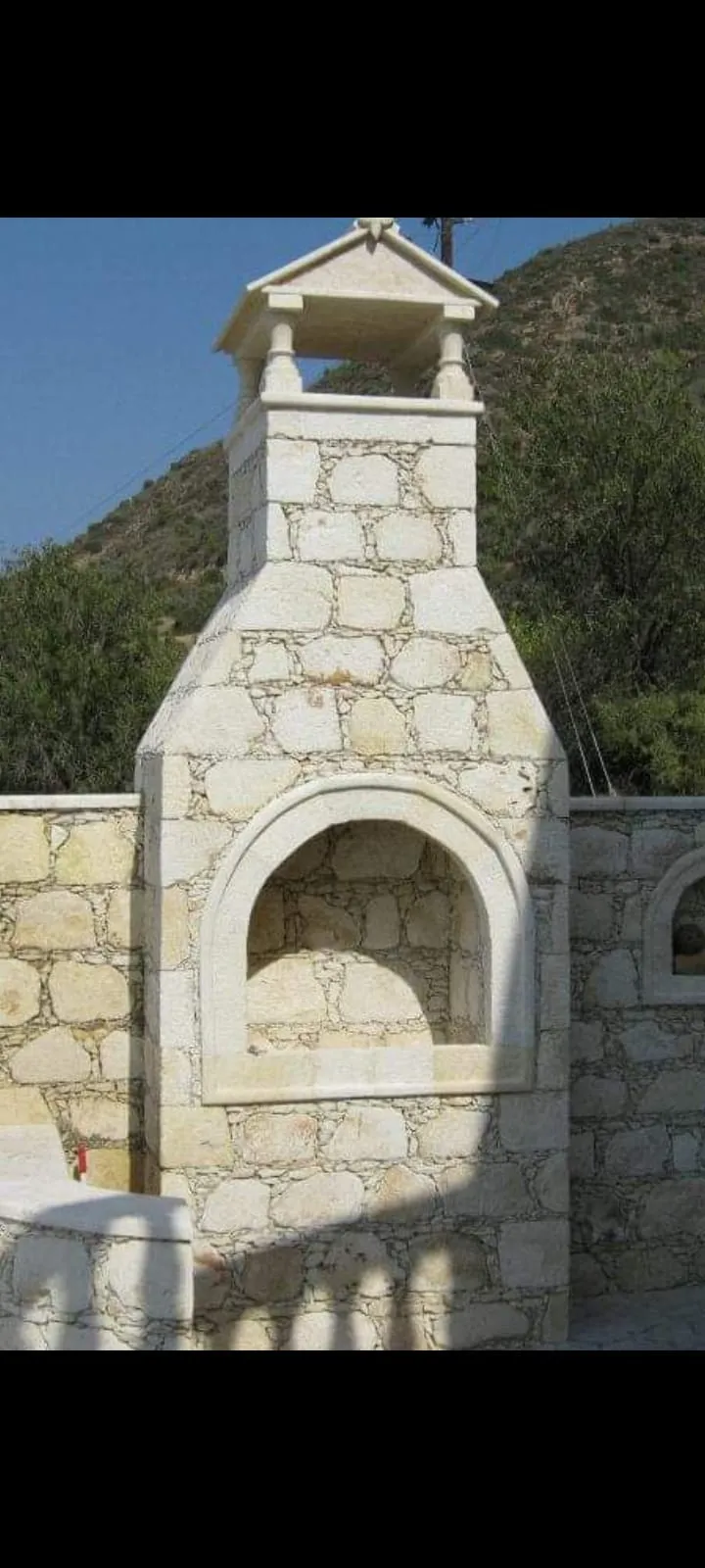 Traditional built-in stone barbecue with a chimney