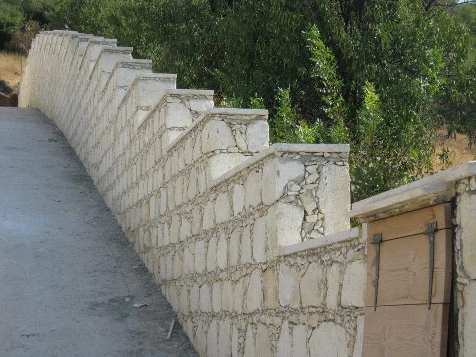 Castellated stone boundary wall in a Cyprus garden