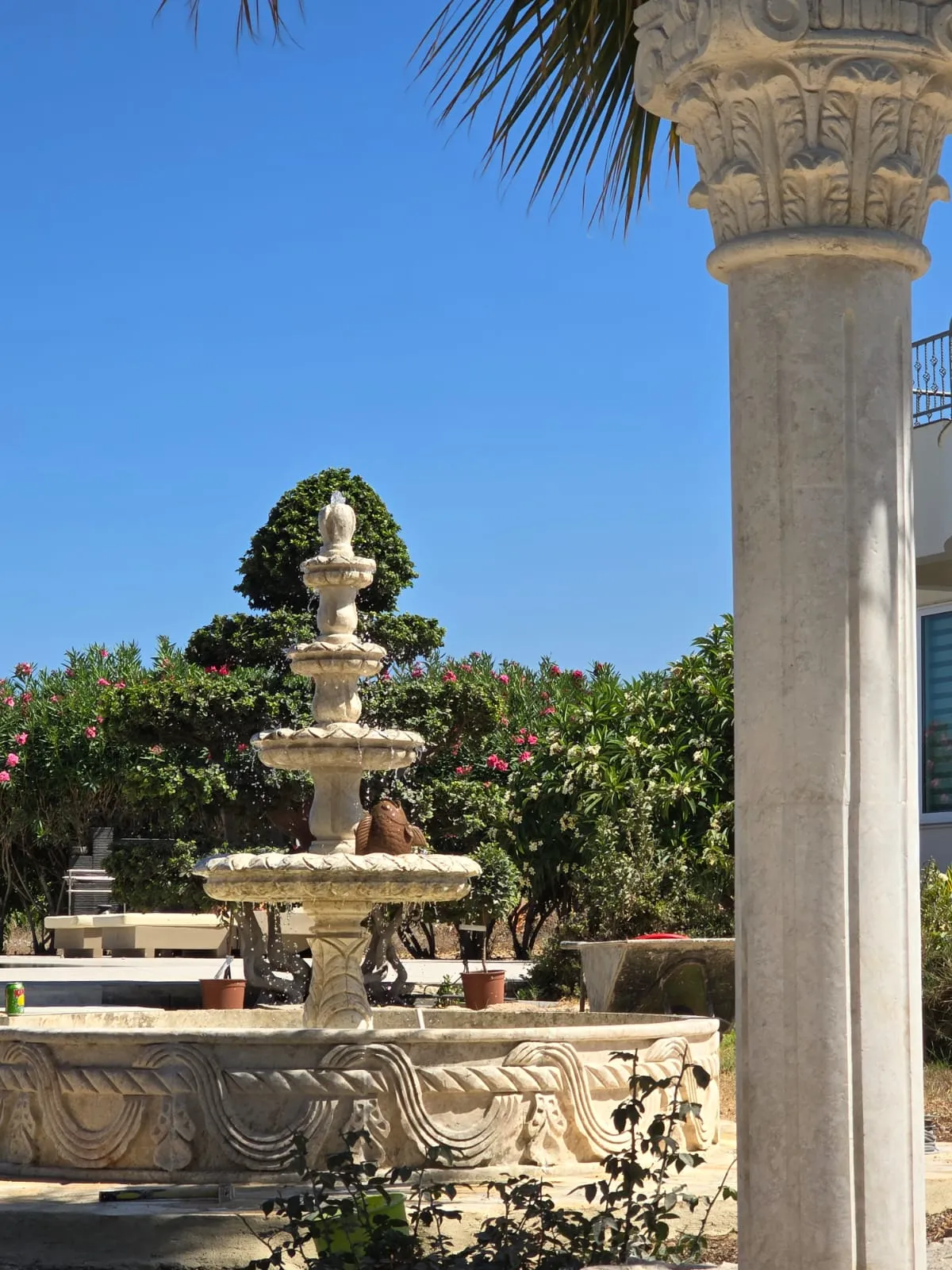 Two-tier carved stone fountain running in a garden