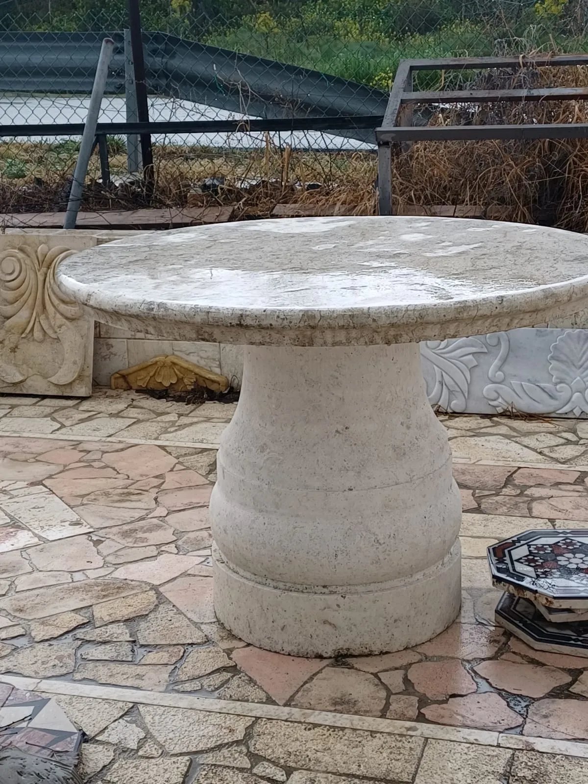 Stone table and seating on a paved patio