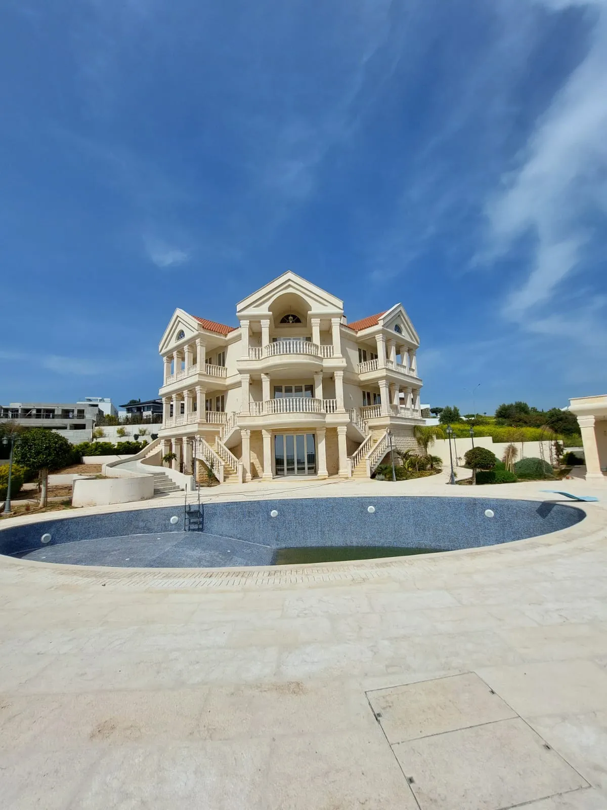 Grand villa with stone columns, balustrades and a pool terrace