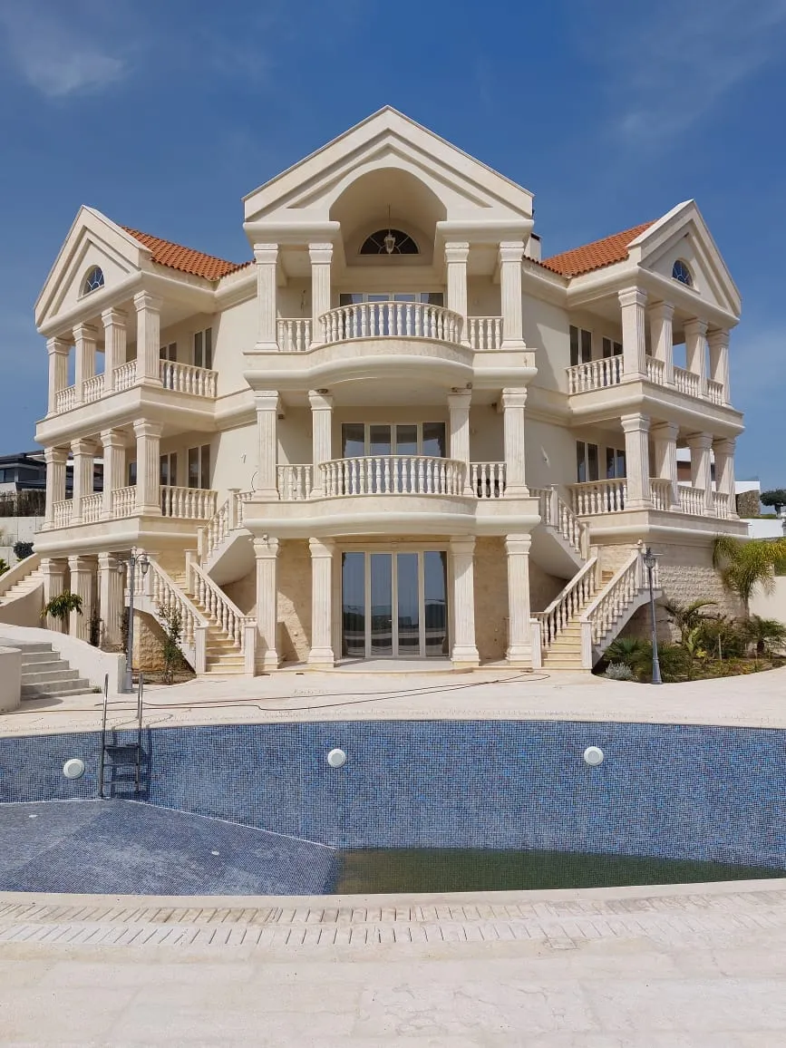 Three-storey stone-clad villa with a pool terrace
