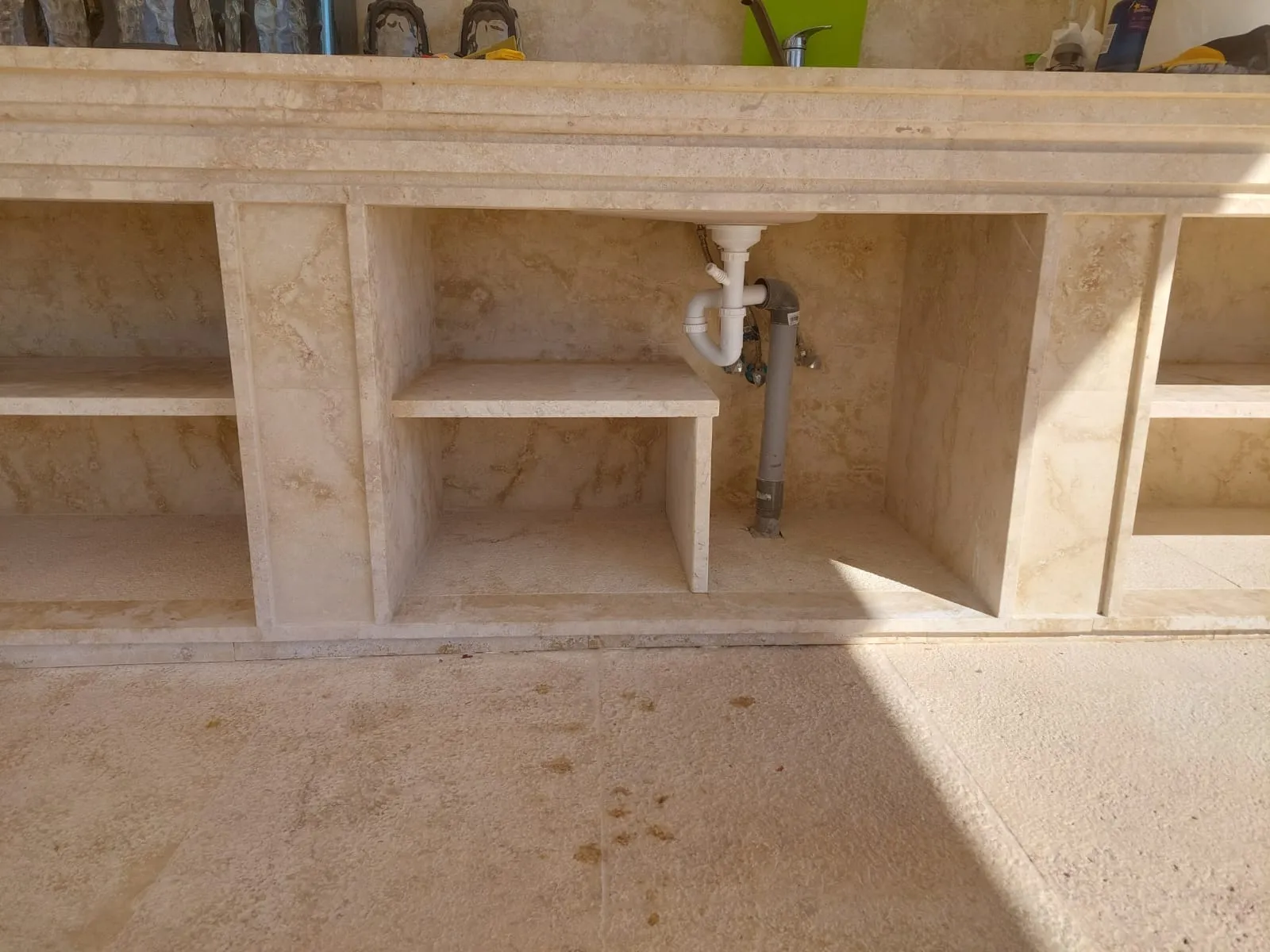 Stone worktop with an integrated sink and open shelving